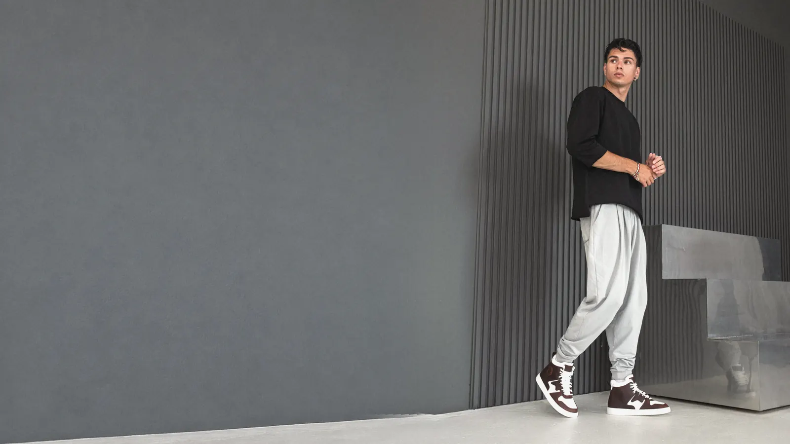 Babylon high-top sneakers with light joggers in a modern interior