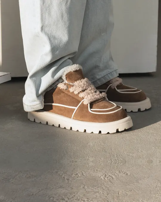 Tan suede Babylon sneakers with fur trim and wide light jeans