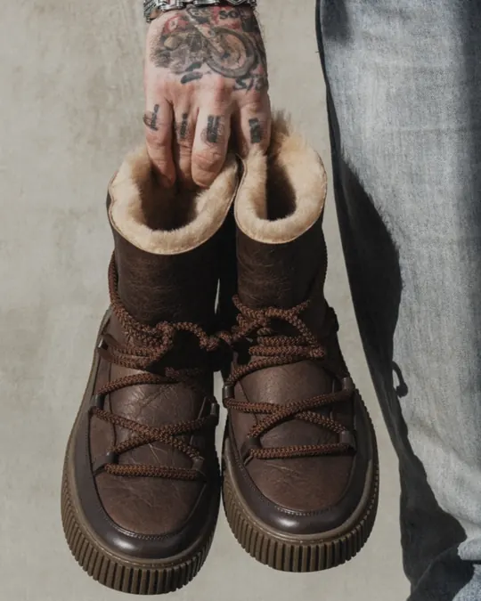 Babylon UG-1-44 sheepskin-lined boots held in hand