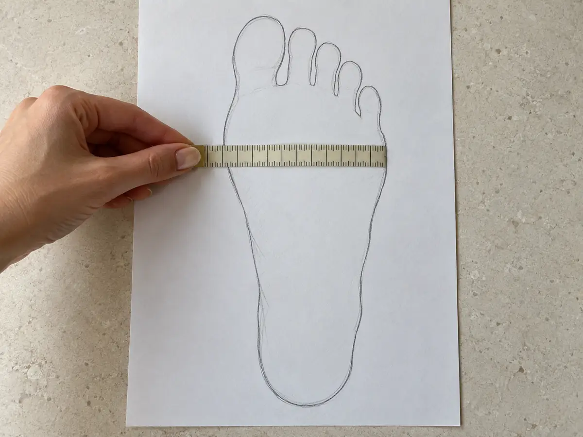 Measuring foot width across the outline on paper