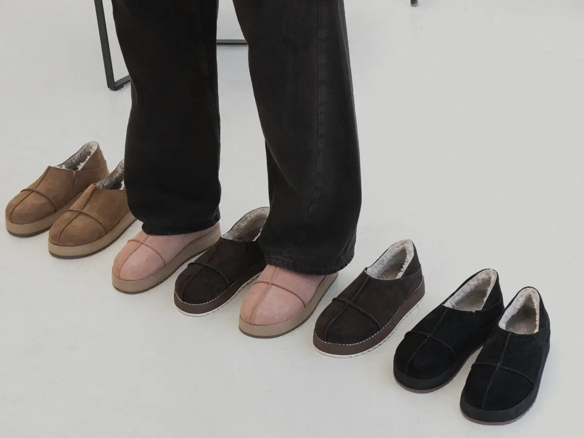 Row of nubuck MARY slip-ons with fur lining: caramel brown, powder pink worn with dark jeans, chocolate and black pairs