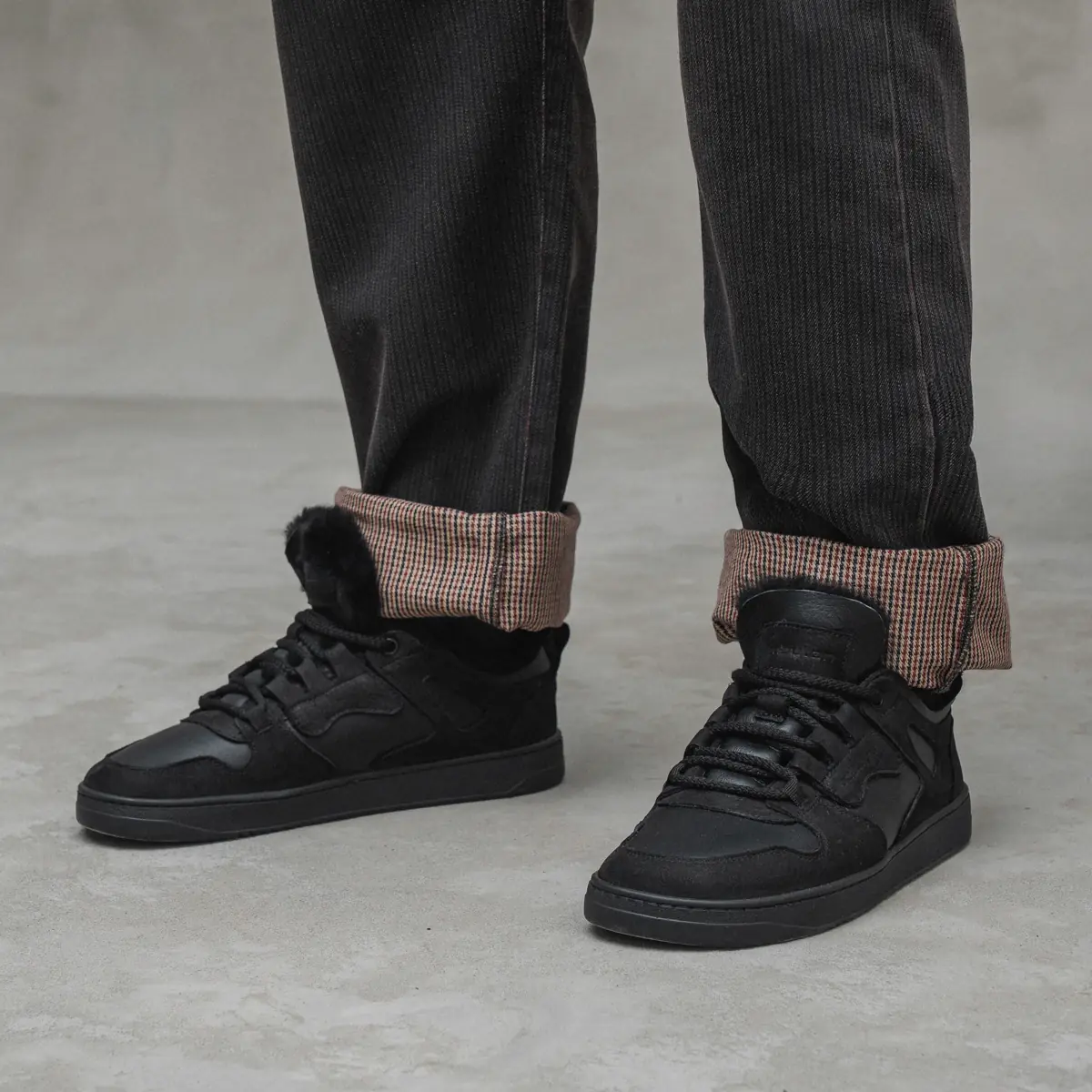 Babylon Space-01-D men's black winter sneakers worn with turned-up trousers, black fur visible at the collar